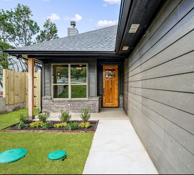 entrance to property with a lawn