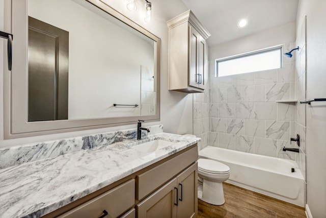 full bath with vanity, wood finished floors, recessed lighting, shower / washtub combination, and toilet