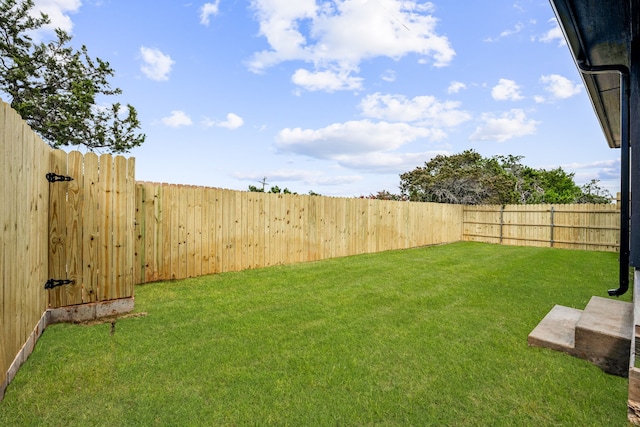 view of yard with a fenced backyard