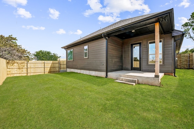 back of property featuring a patio, a lawn, and a fenced backyard