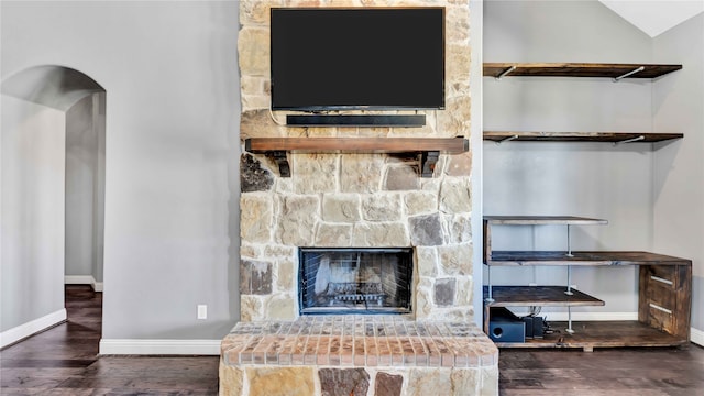 room details with a stone fireplace and hardwood / wood-style floors