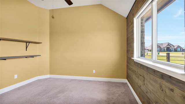 carpeted empty room featuring ceiling fan and lofted ceiling