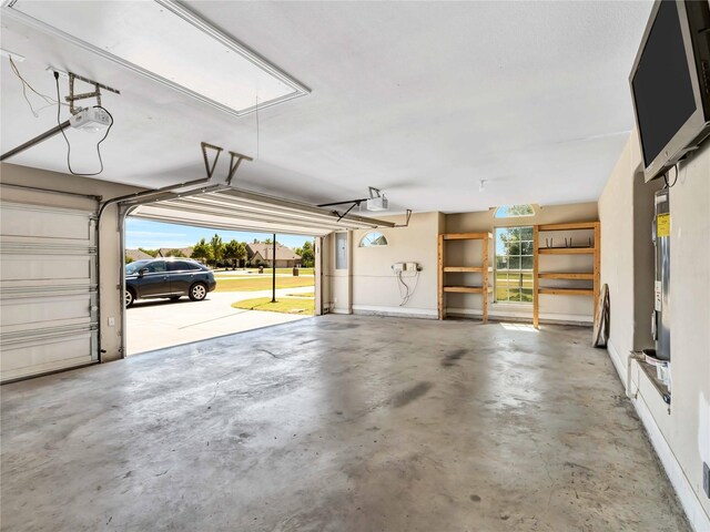 garage with water heater and a garage door opener