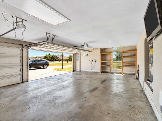 garage featuring electric panel and a garage door opener