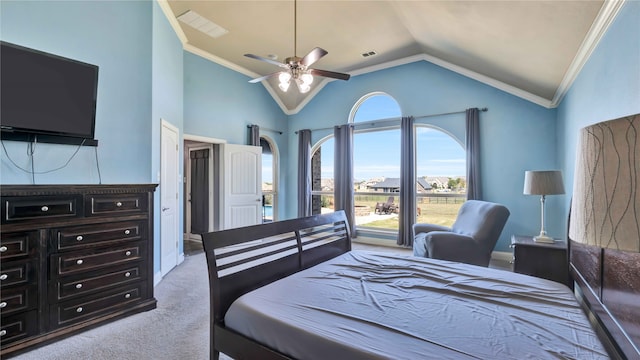 carpeted bedroom featuring ceiling fan, crown molding, and vaulted ceiling