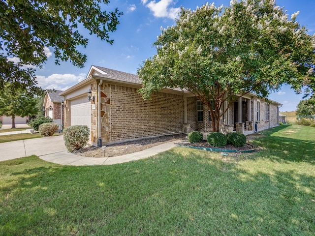 view of front of house featuring a garage, a front lawn, and covered porch