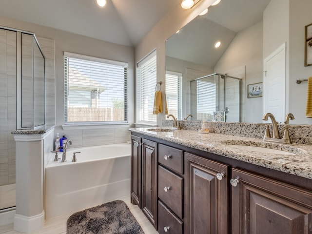 bathroom featuring plus walk in shower, vanity, and lofted ceiling