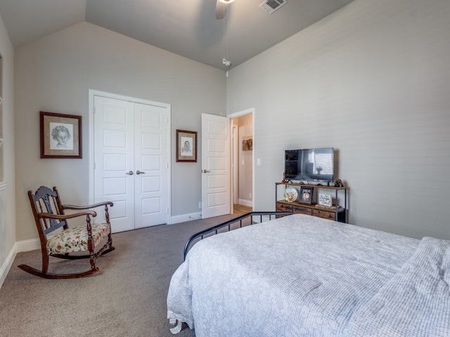 carpeted bedroom with ceiling fan, a closet, and lofted ceiling