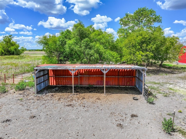 view of pole building featuring a carport and fence