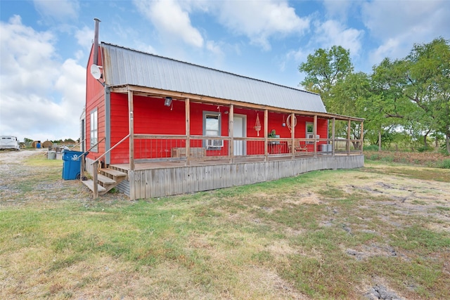 view of outbuilding featuring a lawn and a porch