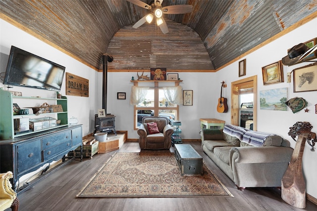 living room with a ceiling fan, a wood stove, wood finished floors, high vaulted ceiling, and wooden ceiling