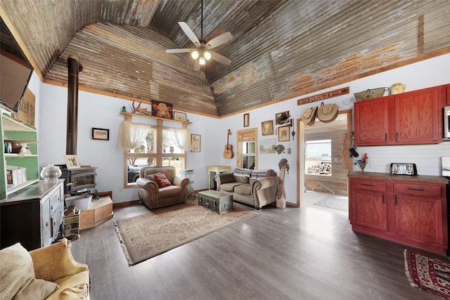 living room featuring dark wood-style floors, a healthy amount of sunlight, and high vaulted ceiling