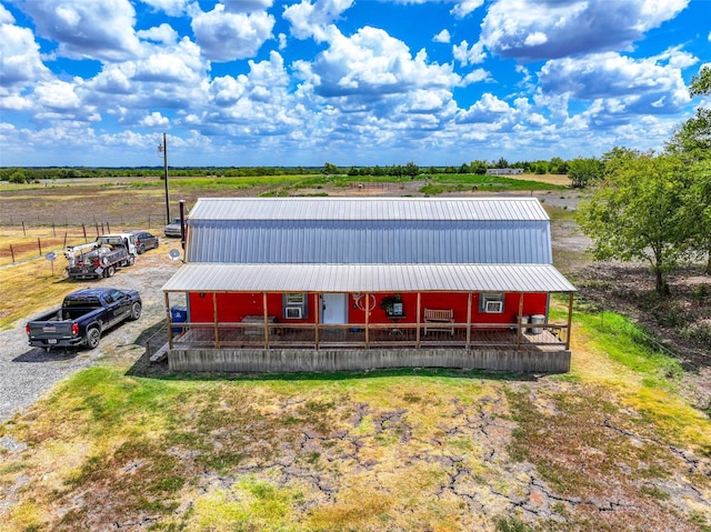 view of front of property featuring metal roof and a rural view