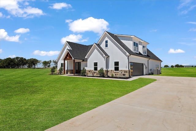 modern farmhouse with an attached garage, central AC unit, concrete driveway, and a front yard