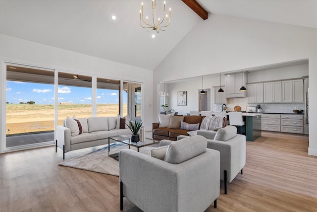 living room featuring high vaulted ceiling, beam ceiling, a notable chandelier, and light hardwood / wood-style flooring