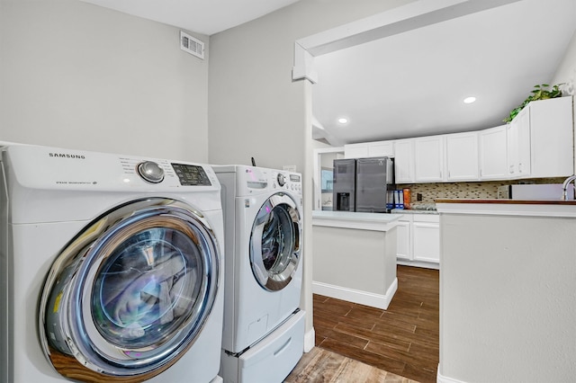 laundry room featuring dark wood-type flooring and washer and clothes dryer