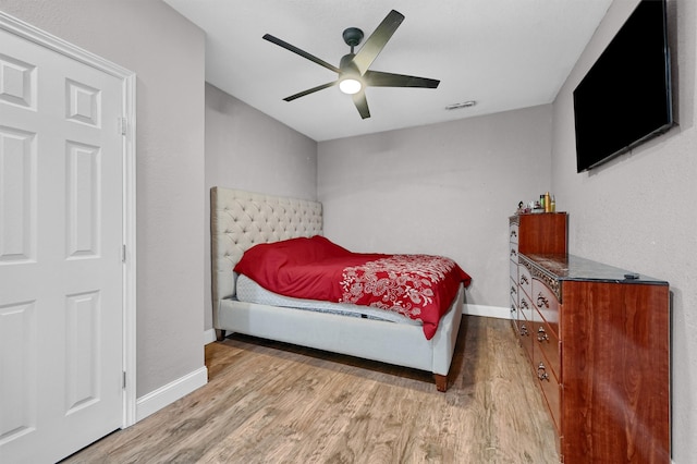 bedroom featuring light hardwood / wood-style flooring and ceiling fan