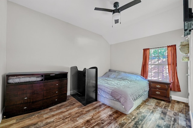 bedroom with lofted ceiling, hardwood / wood-style flooring, and ceiling fan