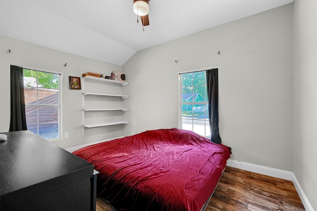 bedroom with dark hardwood / wood-style flooring, ceiling fan, and lofted ceiling