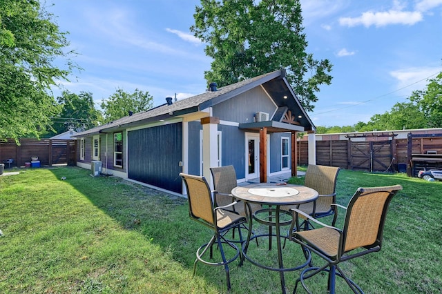 rear view of property with a lawn