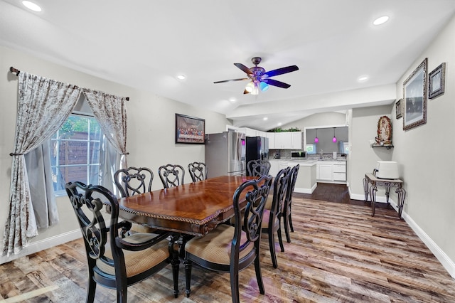 dining area featuring ceiling fan, hardwood / wood-style flooring, and vaulted ceiling