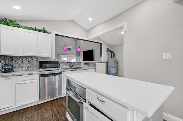 kitchen with backsplash, vaulted ceiling, dark hardwood / wood-style floors, appliances with stainless steel finishes, and white cabinets