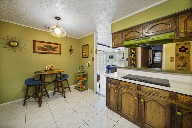 kitchen featuring black electric stovetop, crown molding, a textured ceiling, decorative light fixtures, and dark brown cabinets