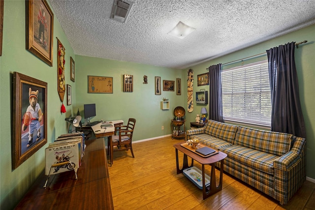 living room featuring hardwood / wood-style floors and a textured ceiling