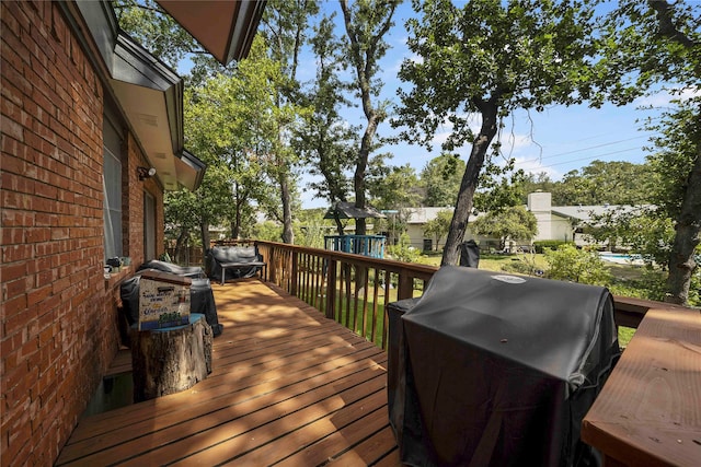 wooden deck featuring a grill