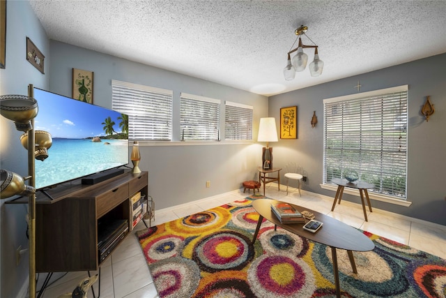 living area with light tile patterned floors and a textured ceiling