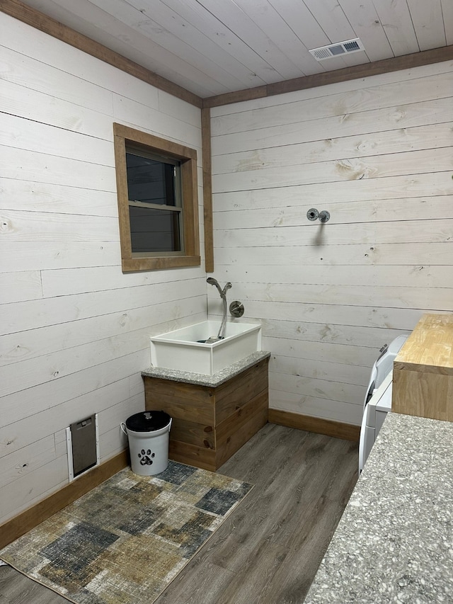 bathroom with wood ceiling, wood walls, and hardwood / wood-style floors