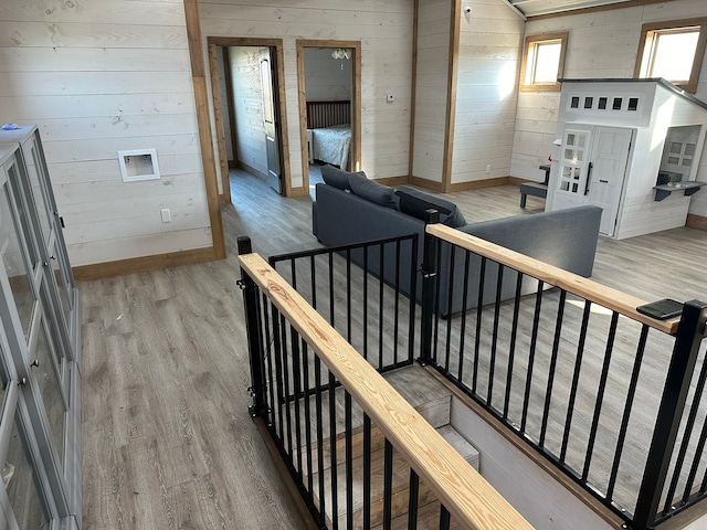 interior space with wood-type flooring and wooden walls