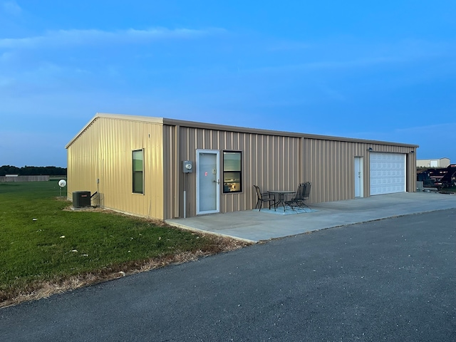 garage featuring a yard and central AC