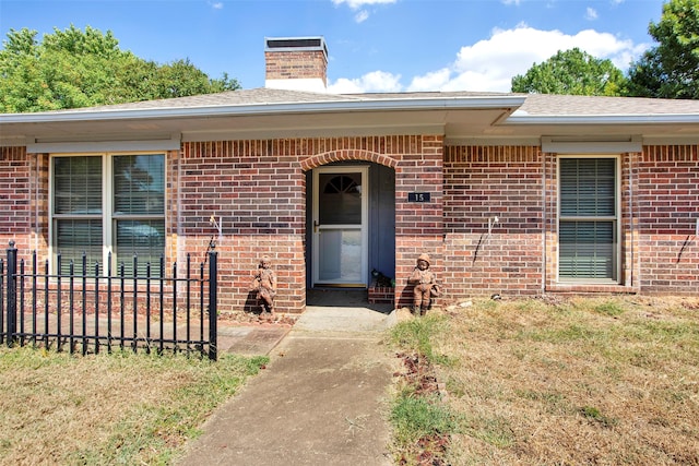 entrance to property with a yard