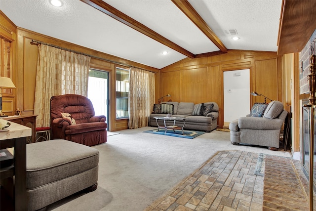 carpeted living room featuring wooden walls, a textured ceiling, and vaulted ceiling with beams