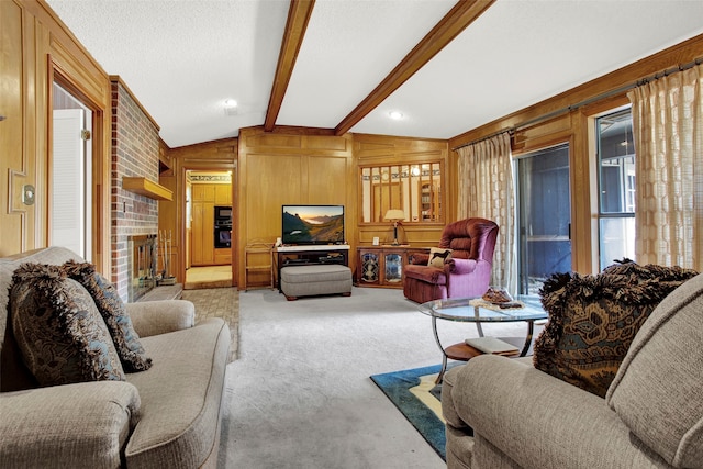 living room featuring light carpet, a brick fireplace, wooden walls, and vaulted ceiling with beams