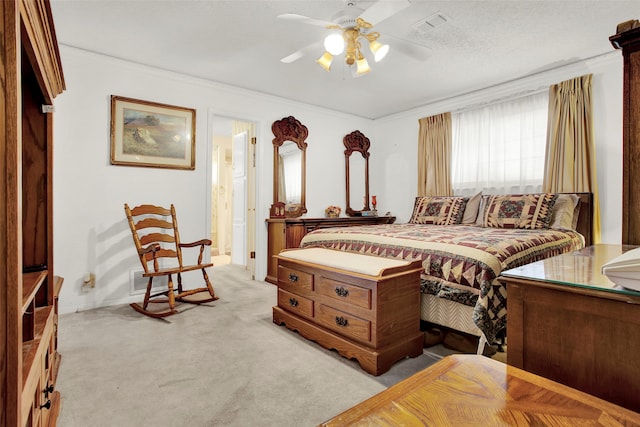 carpeted bedroom with ceiling fan, ornamental molding, and a textured ceiling