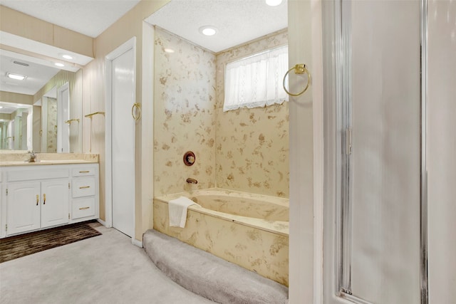 bathroom with vanity, a textured ceiling, and shower with separate bathtub