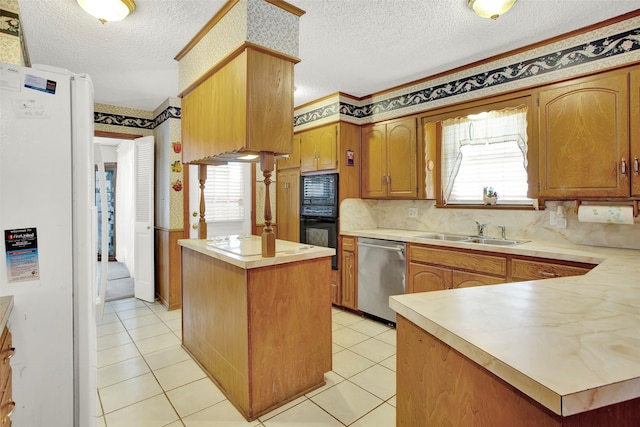 kitchen featuring light tile patterned floors, a center island, sink, black appliances, and decorative backsplash