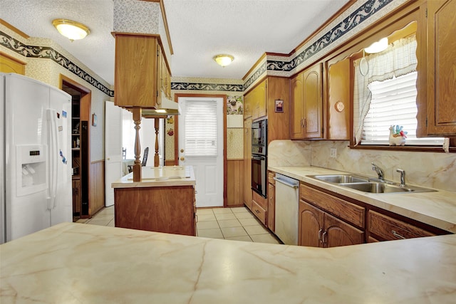 kitchen with black appliances, light tile patterned floors, a textured ceiling, and sink