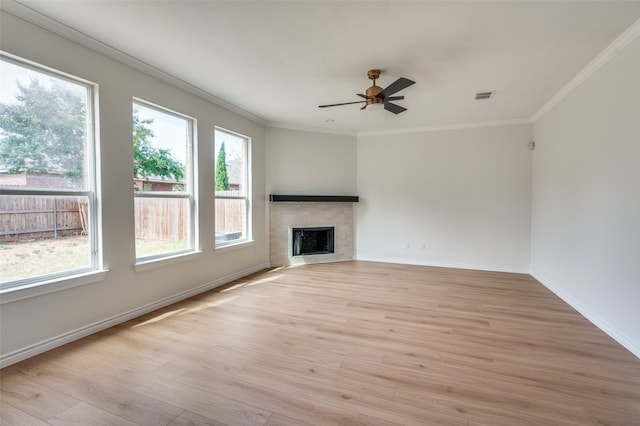 unfurnished living room with a wealth of natural light, ceiling fan, and light wood-type flooring