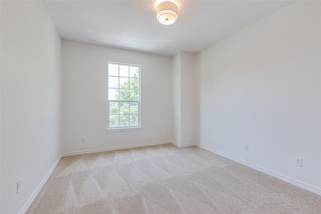 unfurnished room featuring light colored carpet