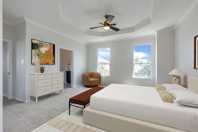 bedroom with a raised ceiling, ceiling fan, ornamental molding, and light carpet