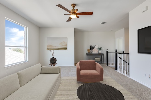 carpeted living room featuring ceiling fan