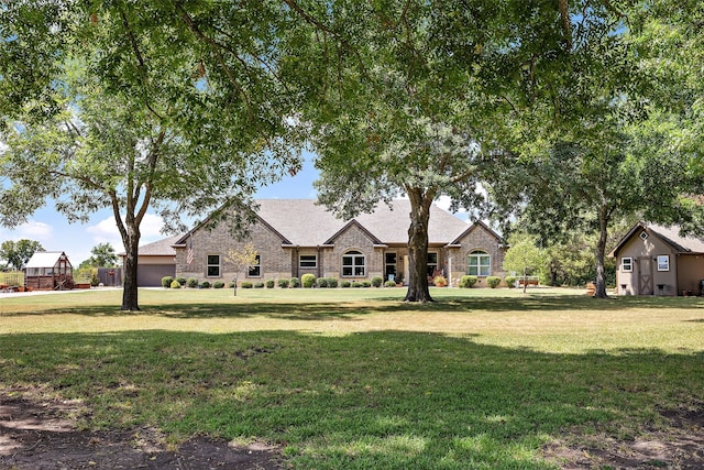 french country home featuring a front yard