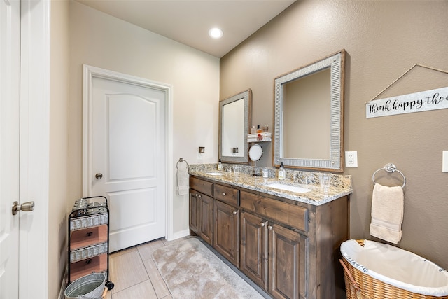 bathroom featuring tile patterned flooring and vanity