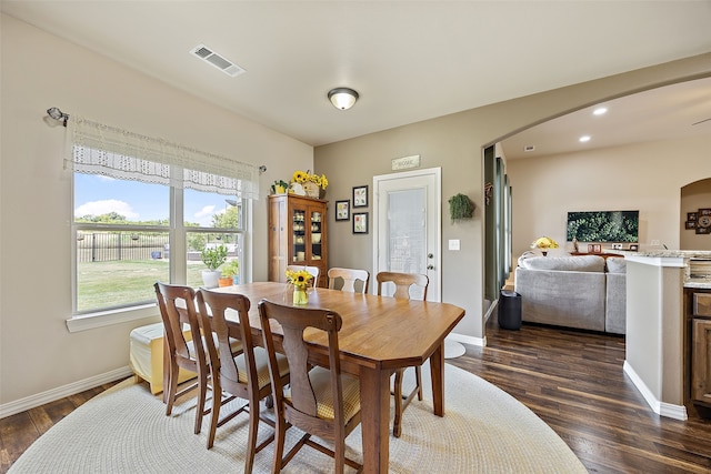 dining space with dark hardwood / wood-style floors