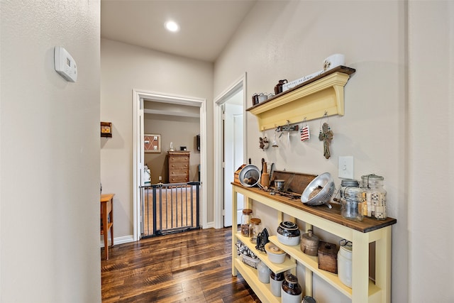 hallway with dark hardwood / wood-style flooring