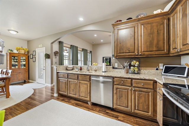 kitchen featuring sink, electric range, light stone countertops, dark hardwood / wood-style floors, and stainless steel dishwasher