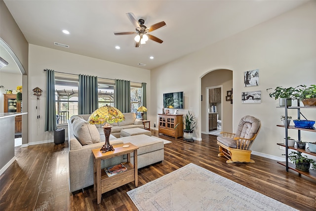 living room with ceiling fan and dark hardwood / wood-style flooring